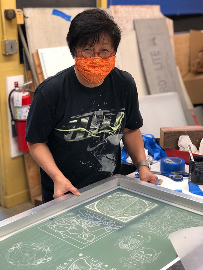 Designer-lecturer Gale Okumara of the UC Davis Department of Design engaged in printing.