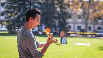 Student throws an atlatl