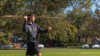 Student throws an atlatl