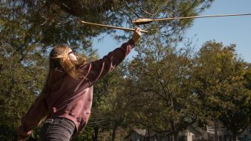 Student throws an atlatl