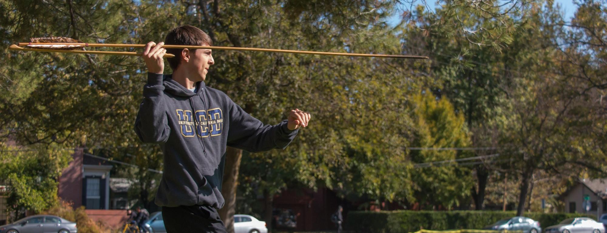 Student throws an atlatl