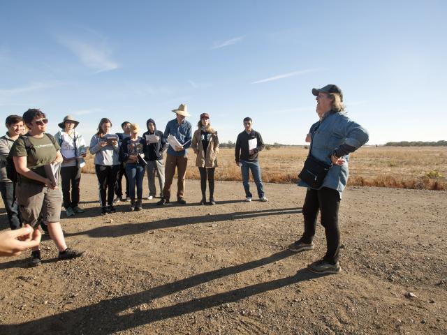Kate Scow with students standing outside
