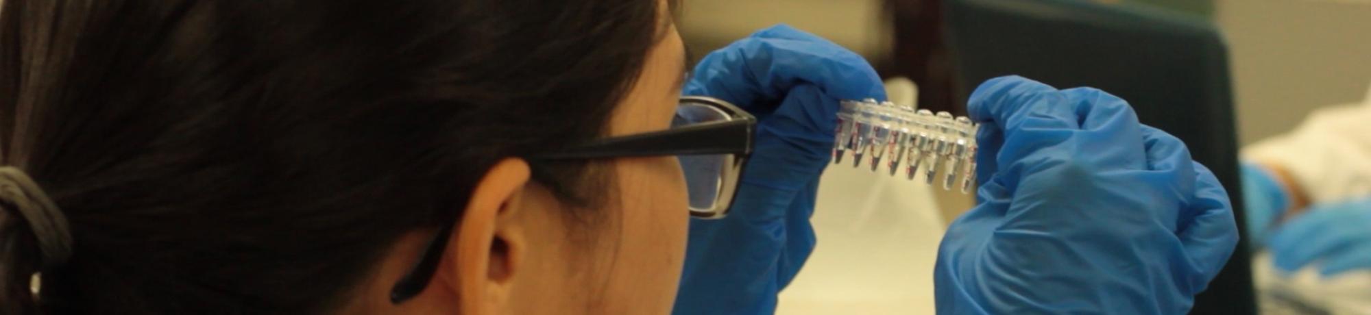 Making a Mutant - woman looking at vials
