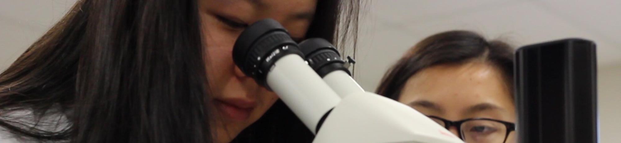 CUREs Seminar Photo - woman looking into microscope