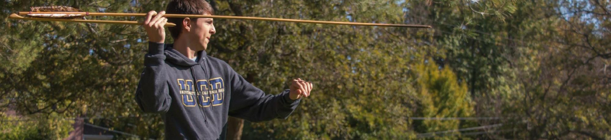 Student throws an atlatl