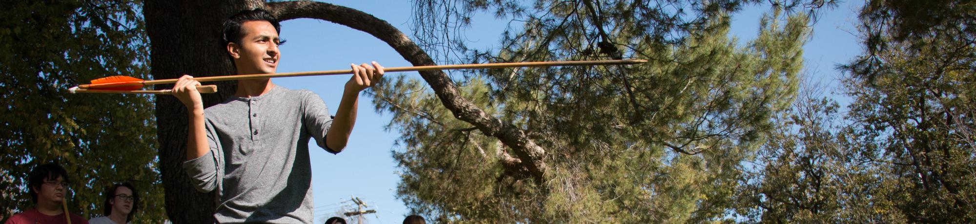 Student throwing an atlatl
