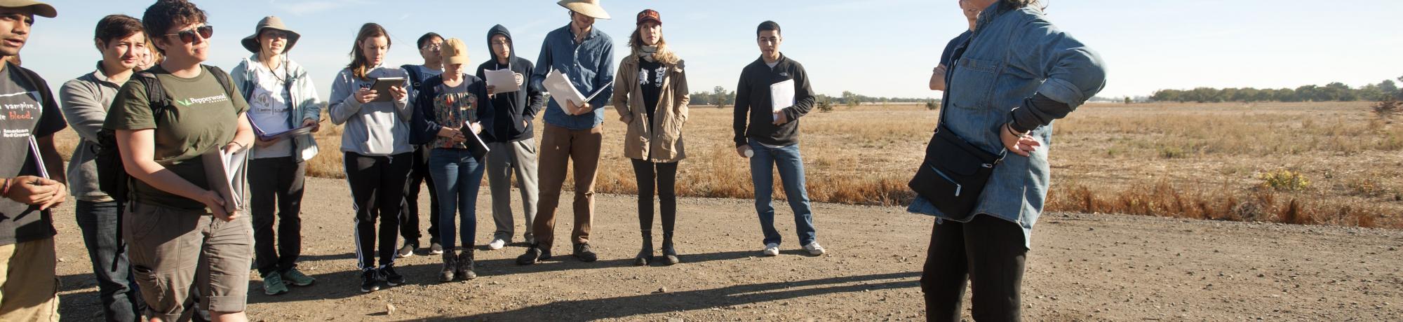 Kate Scow with students standing outside